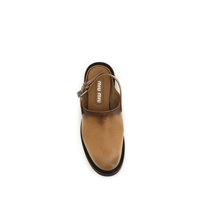 Mules Miu Miu en cuir de veau marron, modèle Bos Taurus