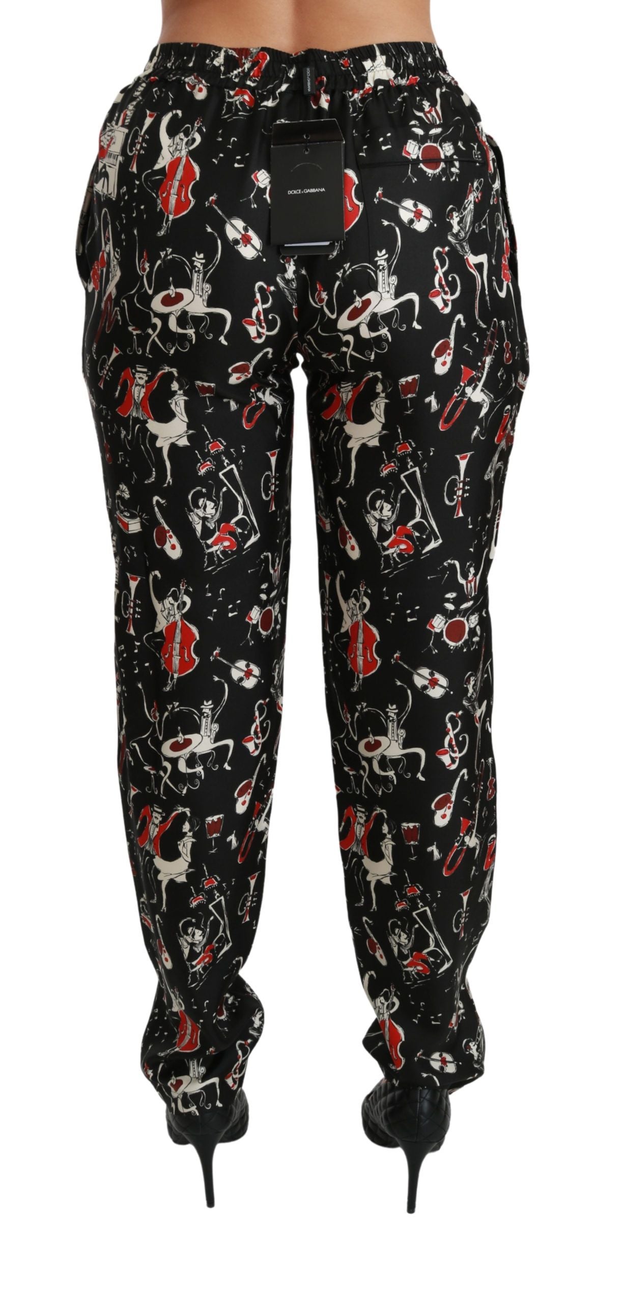Pantalones de seda negros de talle medio con diseño de instrumentos de Dolce & Gabbana