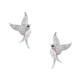 Pair of white gold-plated hummingbird stud earrings with pavé zirconia stones and teardrop crystal bodies on cream background