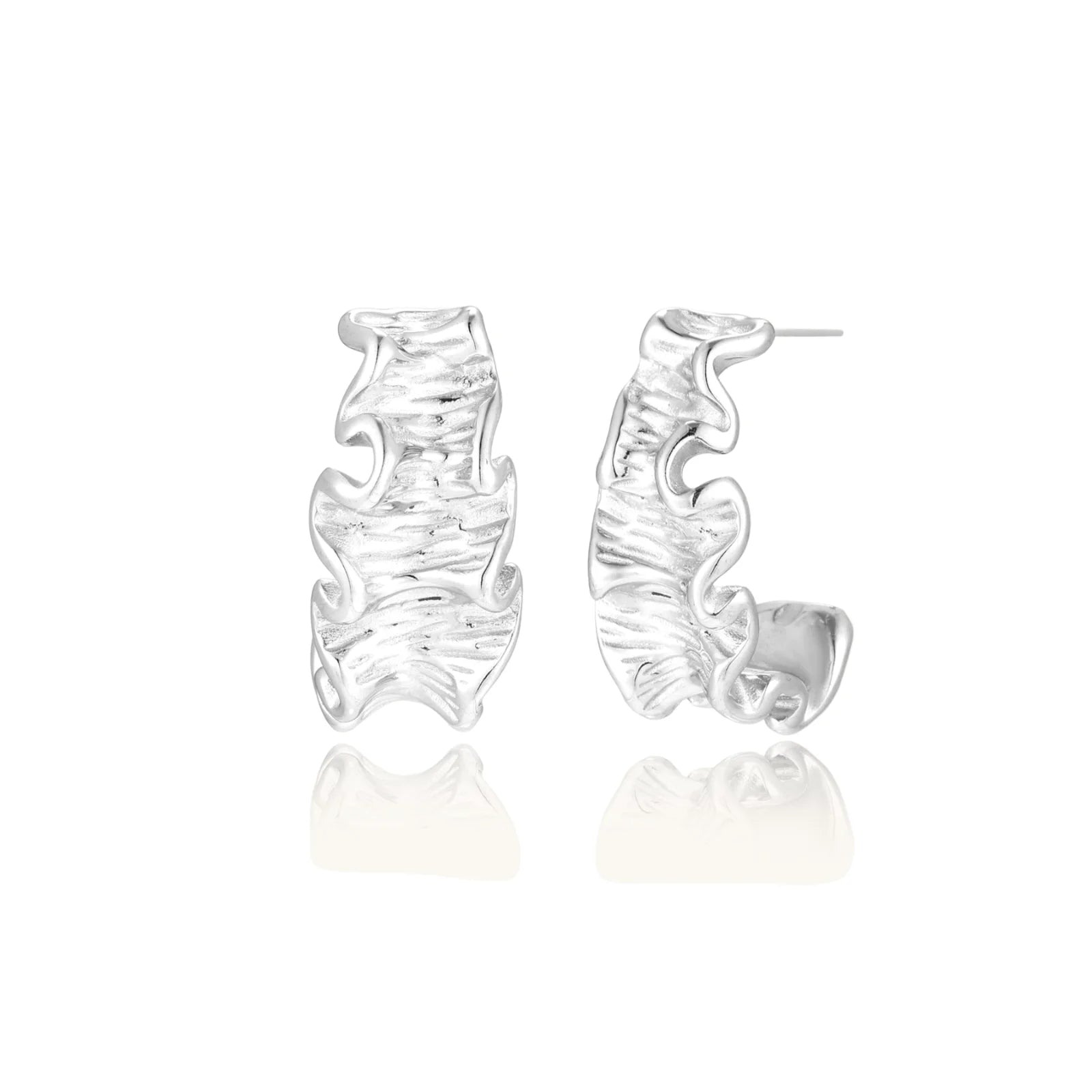 White gold plated sculptural hoop earrings with organic wavy edges and reflective metallic finish on cream background