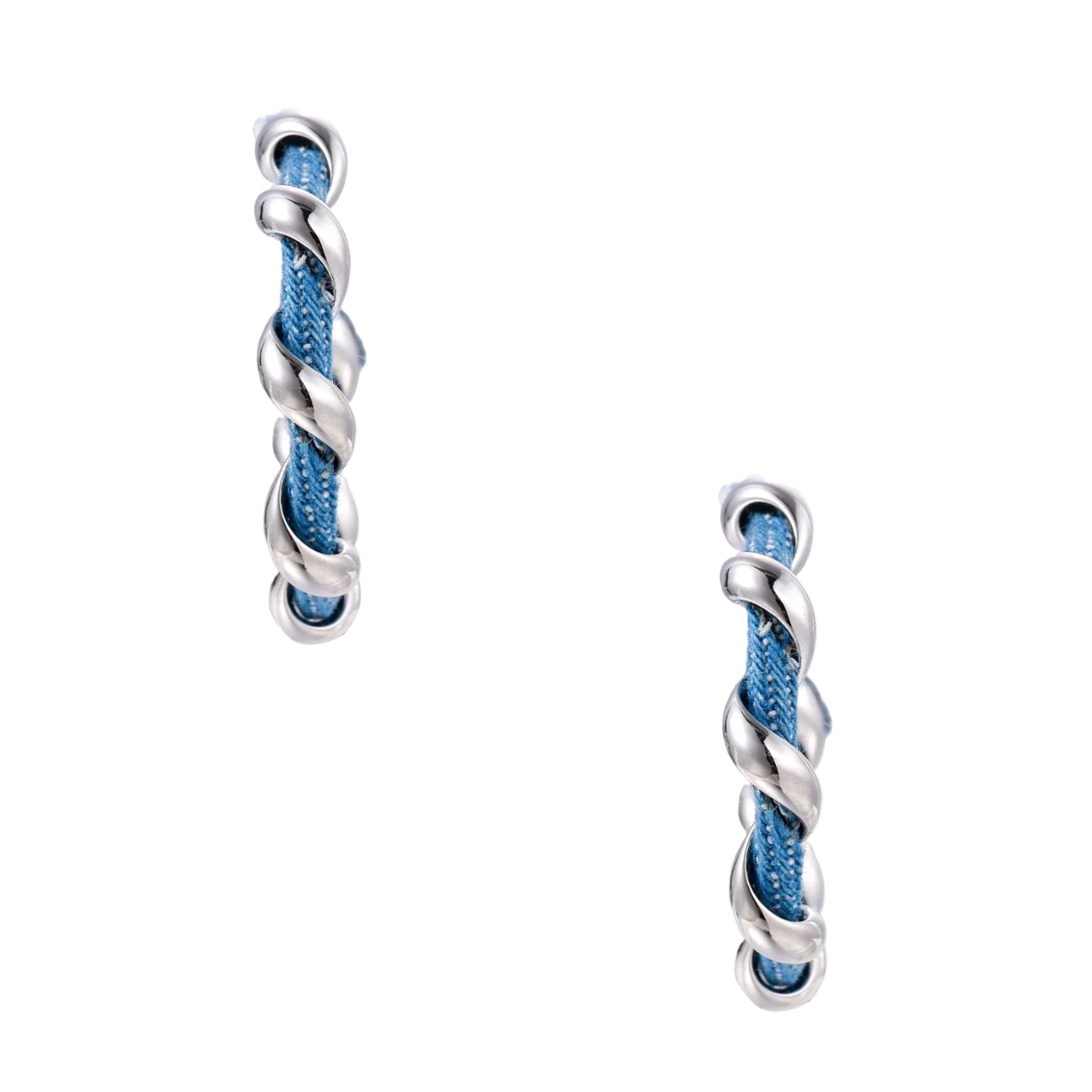 White gold-plated hoops intertwined with blue denim fabric in a twisted rope design on cream background.