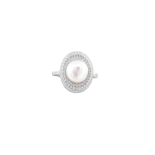 Silver ring with lustrous white pearl center surrounded by sparkling crystal halo on light background.