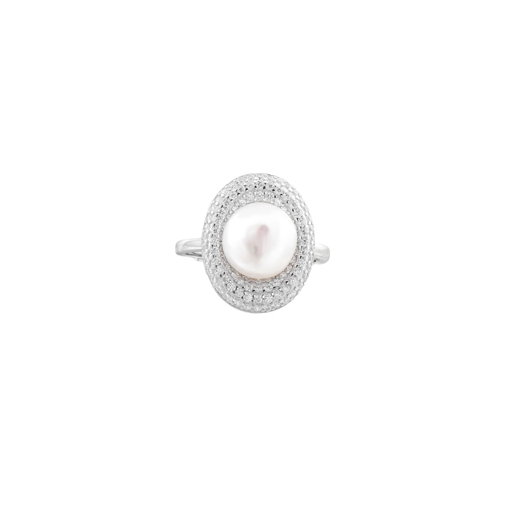 Silver ring with lustrous white pearl center surrounded by sparkling crystal halo on light background.