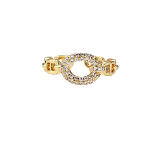 Gold-plated brass chain link ring with one oval CZ-pavé segment on cream background, adjustable cuff style.