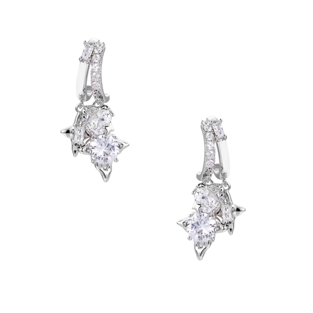White gold-plated huggie earrings with geometric emerald-cut zirconia clusters in starburst formation on beige background