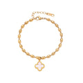 18K gold-plated oval bead chain bracelet with quatrefoil clover charm featuring mother of pearl inlay on cream background