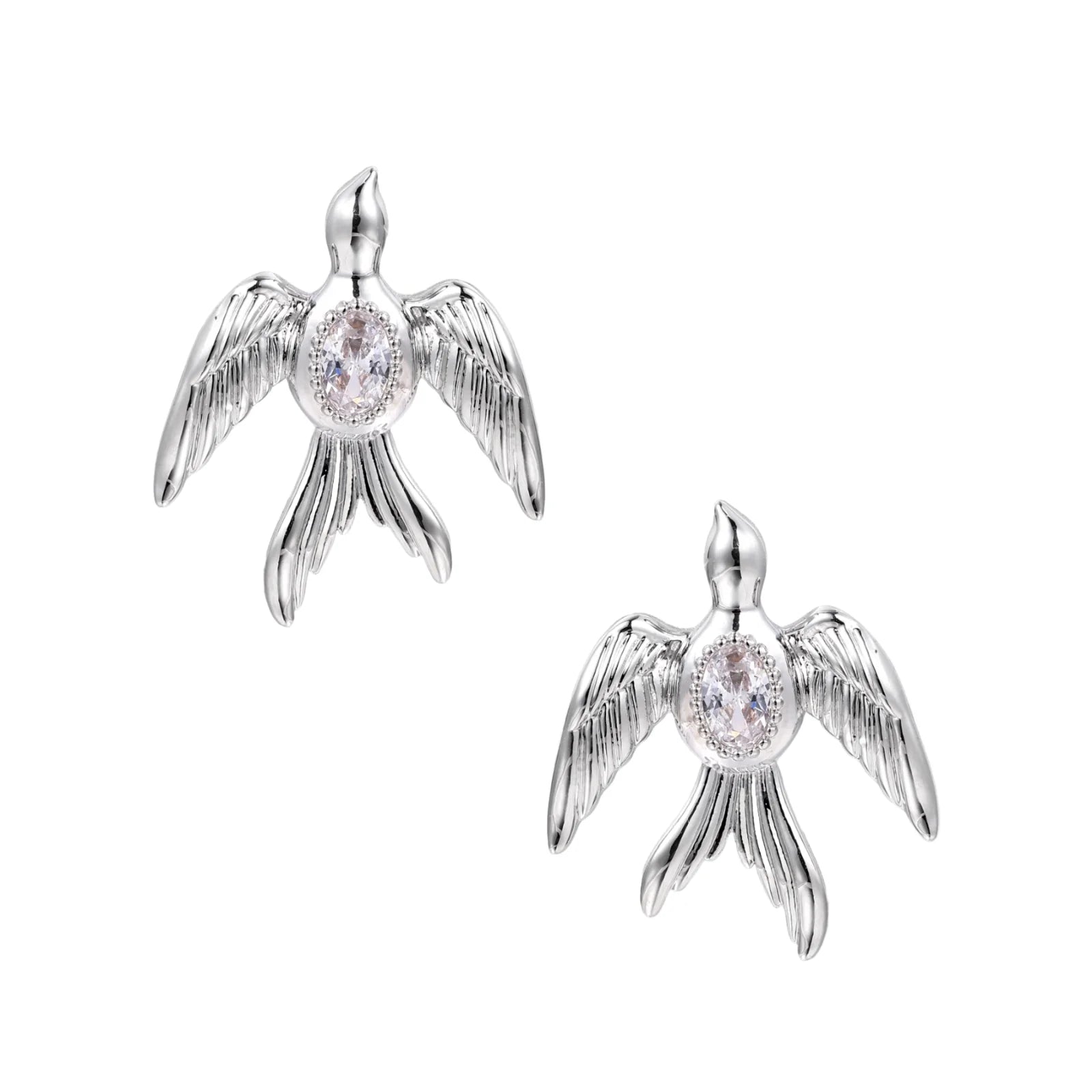 White gold-plated bird earrings with spread wings and oval zirconia center on cream background