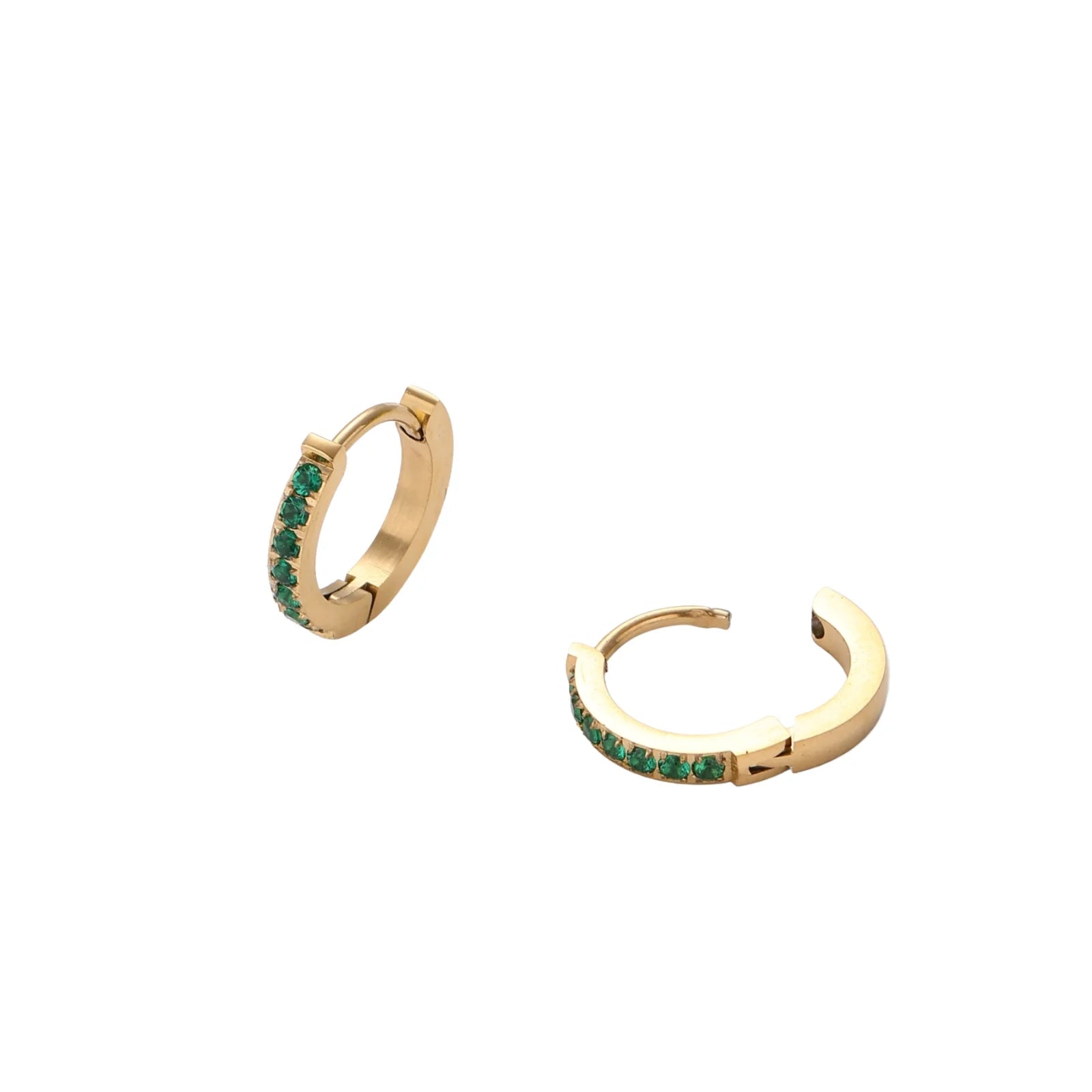 Pair of small gold huggie hoop earrings with bright green cubic zirconia stones on cream background