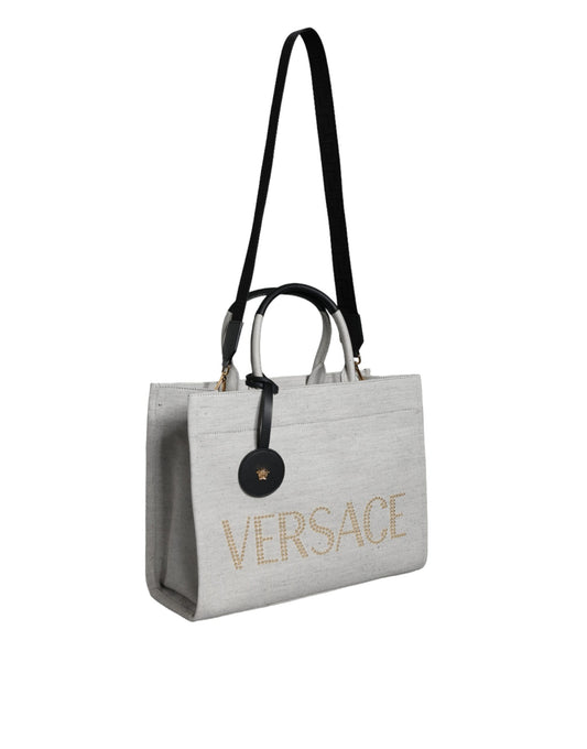 Bolso tote cruzado de lona y cuero con asa superior, logo y color blanco de Versace