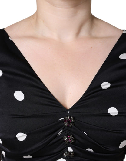 Vestido midi de seda negra con lunares, escote en V y borlas de Dolce & Gabbana