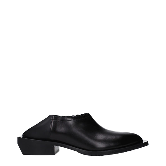 Mules de cuero negro Moschino