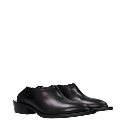 Mules de cuero negro Moschino