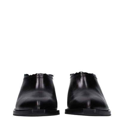 Mules de cuero negro Moschino