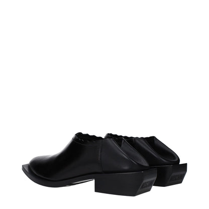 Mules de cuero negro Moschino