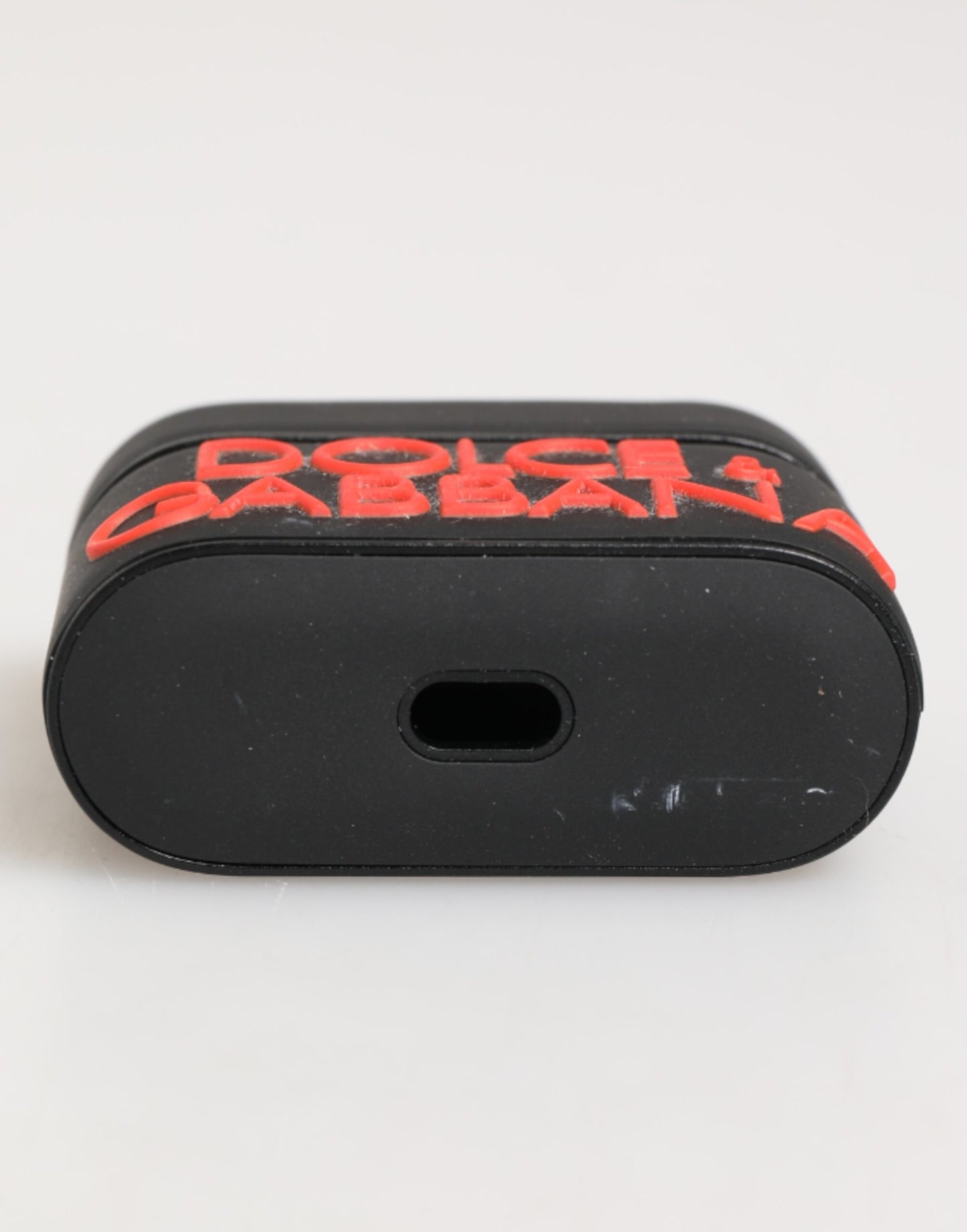 Funda para Airpods Dolce & Gabbana negra, naranja, de goma con logo grabado en relieve